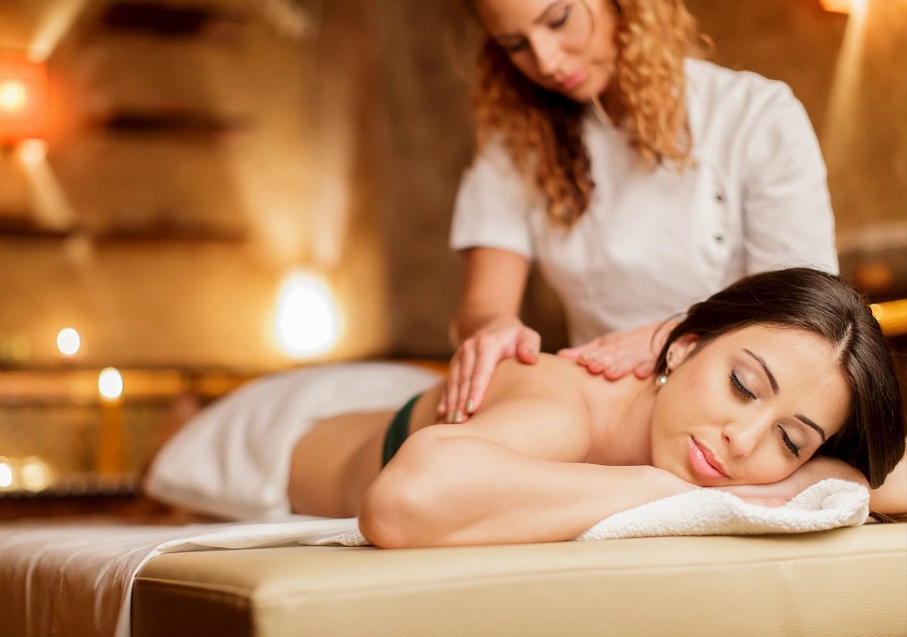 A woman getting a massage from a masseuse.